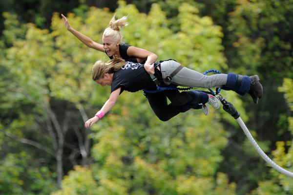 Playboy Playmate Jordan Monroe (top) & Belinda Henley perform a tandem bungy in Queenstown